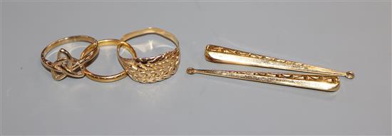 A 22ct gold wedding band, 2.6 grams, an unmarked gold knot ring, another ring and a pair of drop earrings